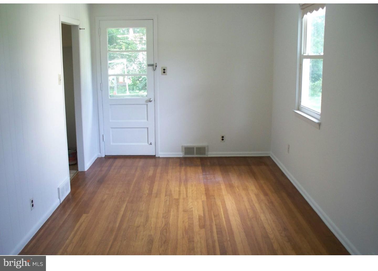 207 Spruce Road Flourtown, PA 19031 - Photo 5 of 19 an empty room with wooden floor and windows