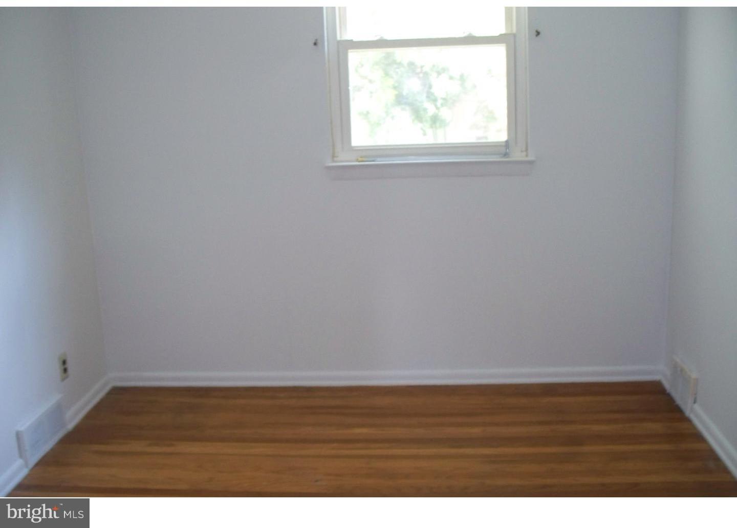 207 Spruce Road Flourtown, PA 19031 - Photo 10 of 19 a view of an empty room with wooden floor and a window