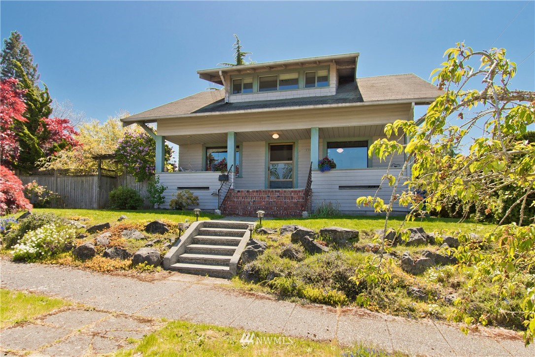 7501 California Avenue Southwest Seattle, WA 98136 - Photo 1 of 25 a front view of a house with a yard