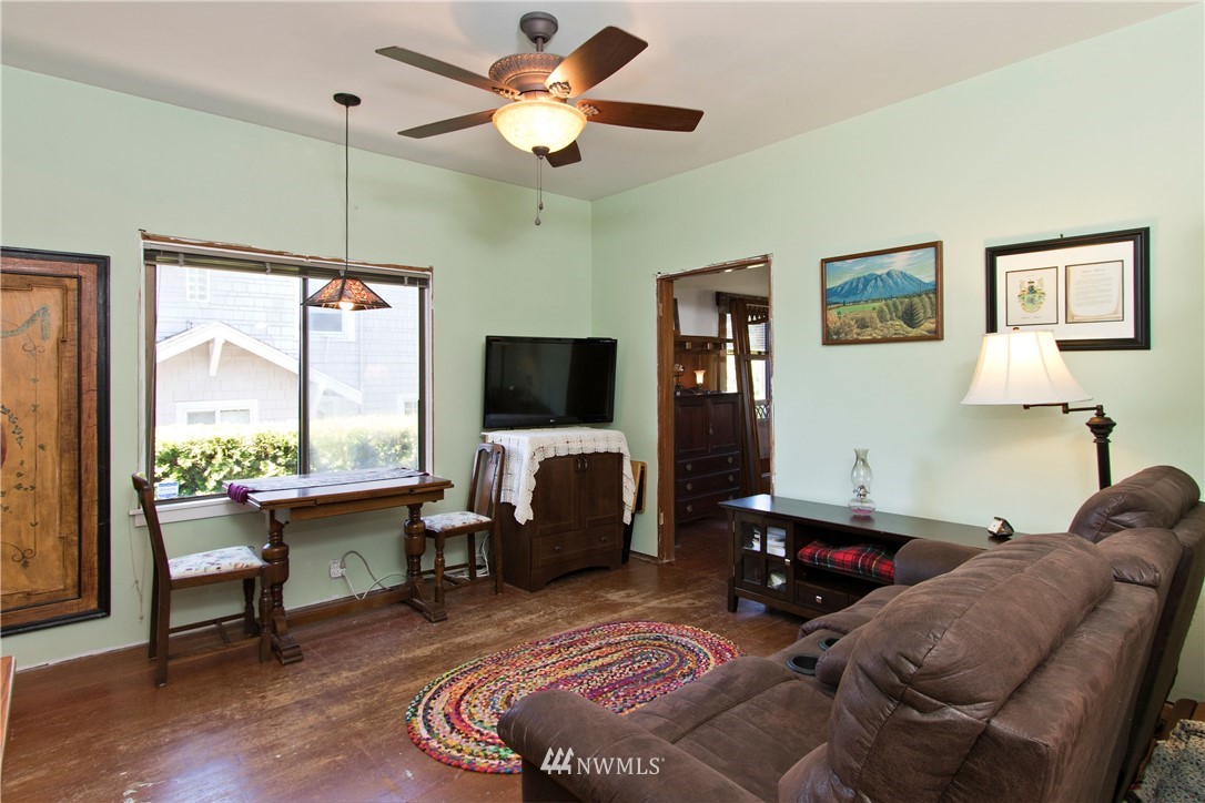 7501 California Avenue Southwest Seattle, WA 98136 - Photo 13 of 25 a living room with furniture a flat screen tv and a large window