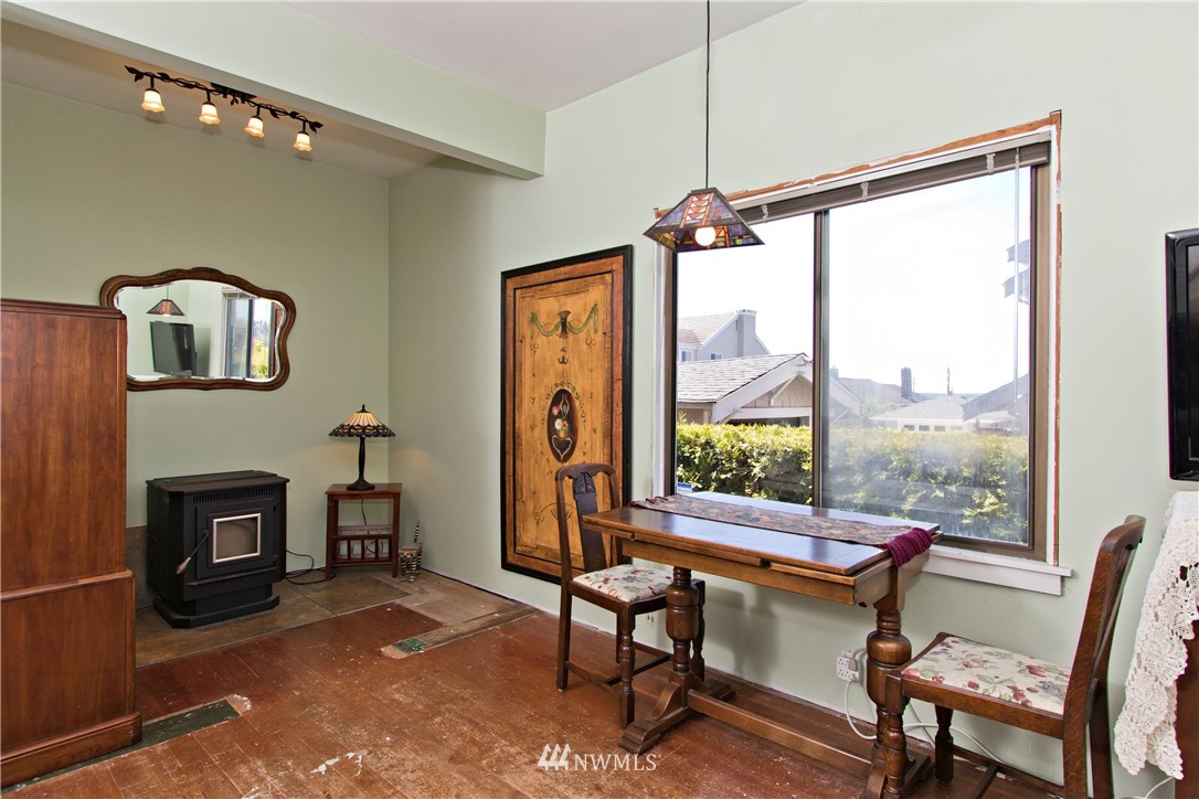7501 California Avenue Southwest Seattle, WA 98136 - Photo 14 of 25 a living room with furniture a fireplace and a floor to ceiling window