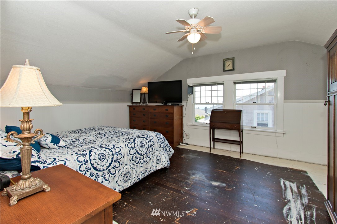 7501 California Avenue Southwest Seattle, WA 98136 - Photo 17 of 25 a bedroom with furniture and a flat screen tv