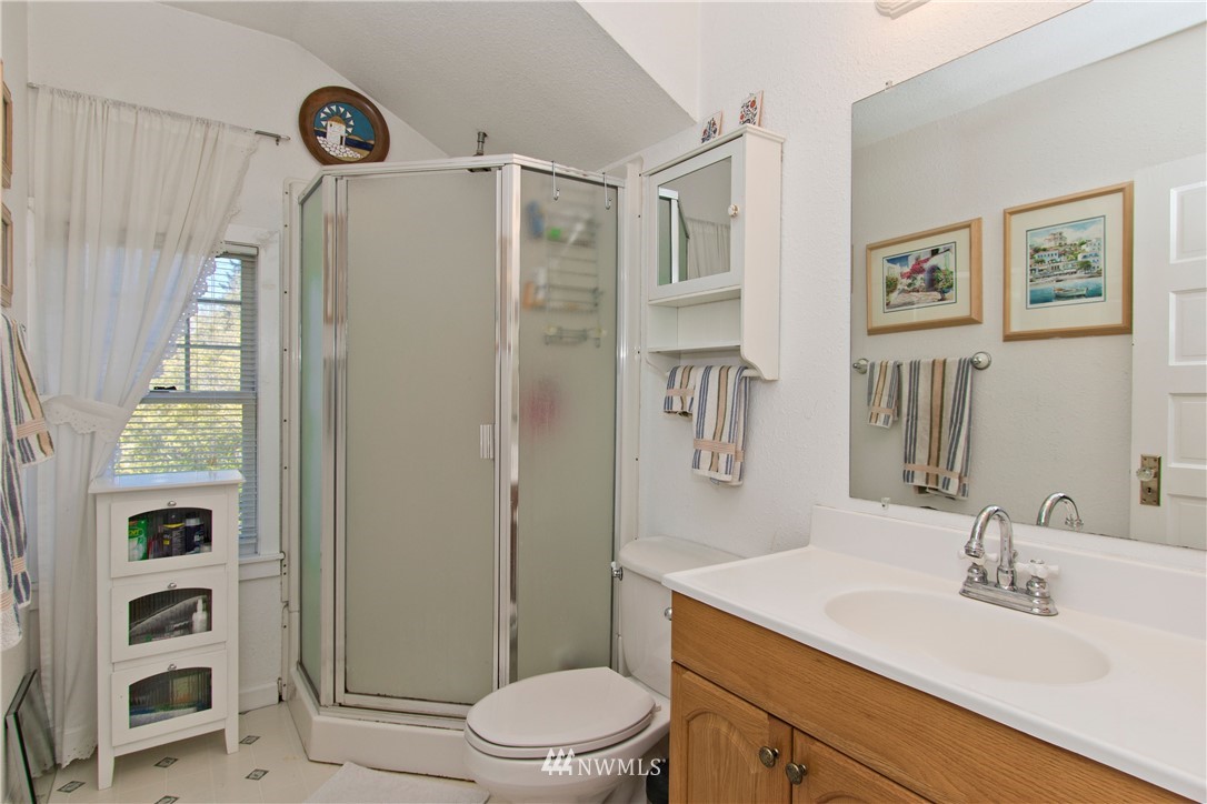 7501 California Avenue Southwest Seattle, WA 98136 - Photo 18 of 25 a bathroom with a sink a toilet and shower