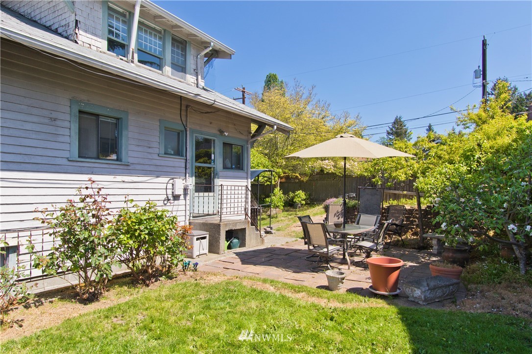 7501 California Avenue Southwest Seattle, WA 98136 - Photo 24 of 25 a view of a patio with table and chairs under an umbrella