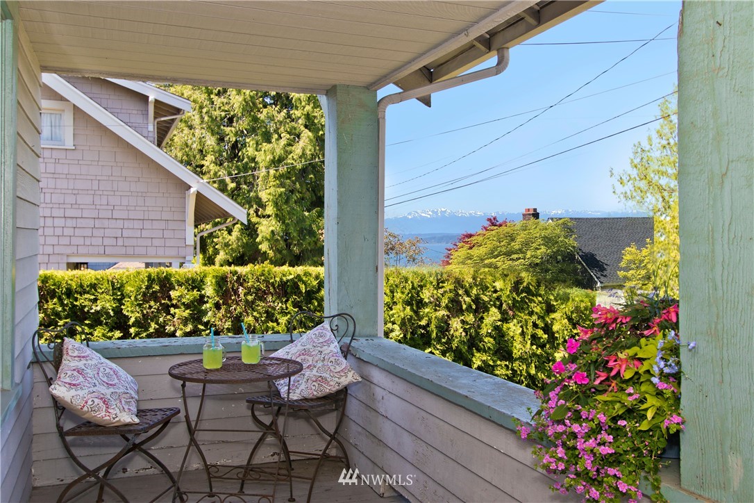 7501 California Avenue Southwest Seattle, WA 98136 - Photo 4 of 25 a wooden bench sitting in front of a house