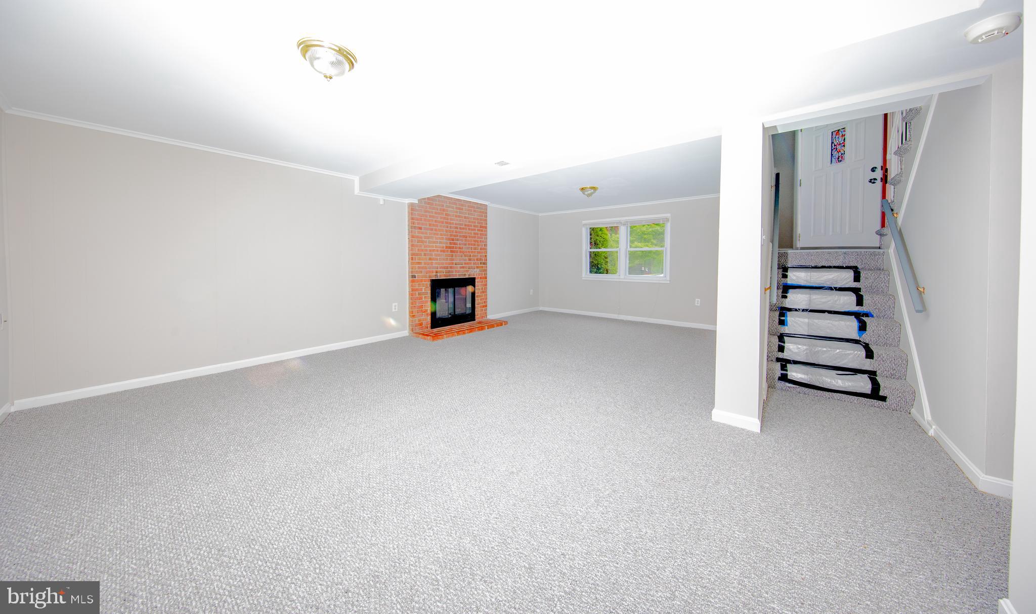13806 Delaney Road Woodbridge, VA 22193 - Photo 8 of 10 Spacious recreation room w walk out and fireplace
