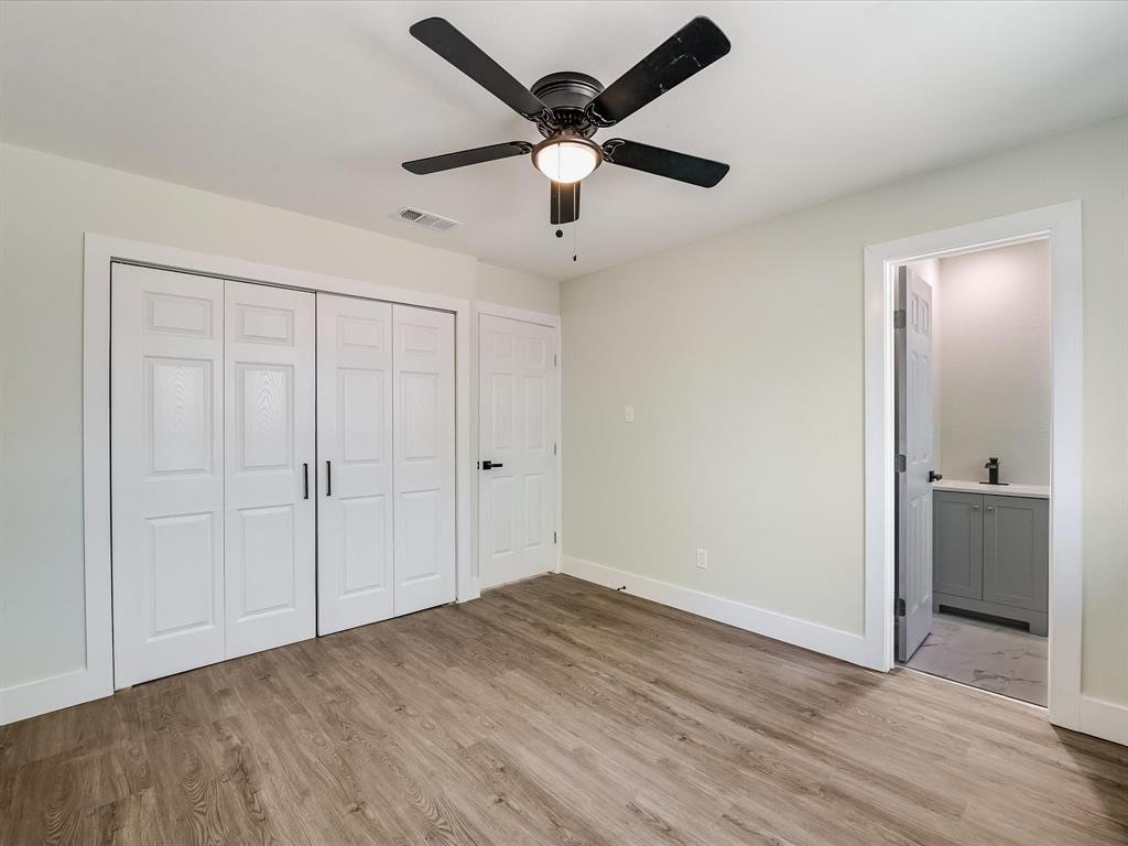 7004 Craybrough Circle Austin, TX 78724 - Photo 8 of 19 A well-lit bedroom features durable plank flooring and convenient access to an en-suite bath.