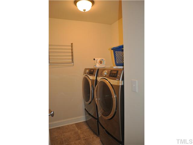 808 Pirouette Court Raleigh, NC 27606 - Photo 16 of 25 Laundry room has drying rack and a closet.