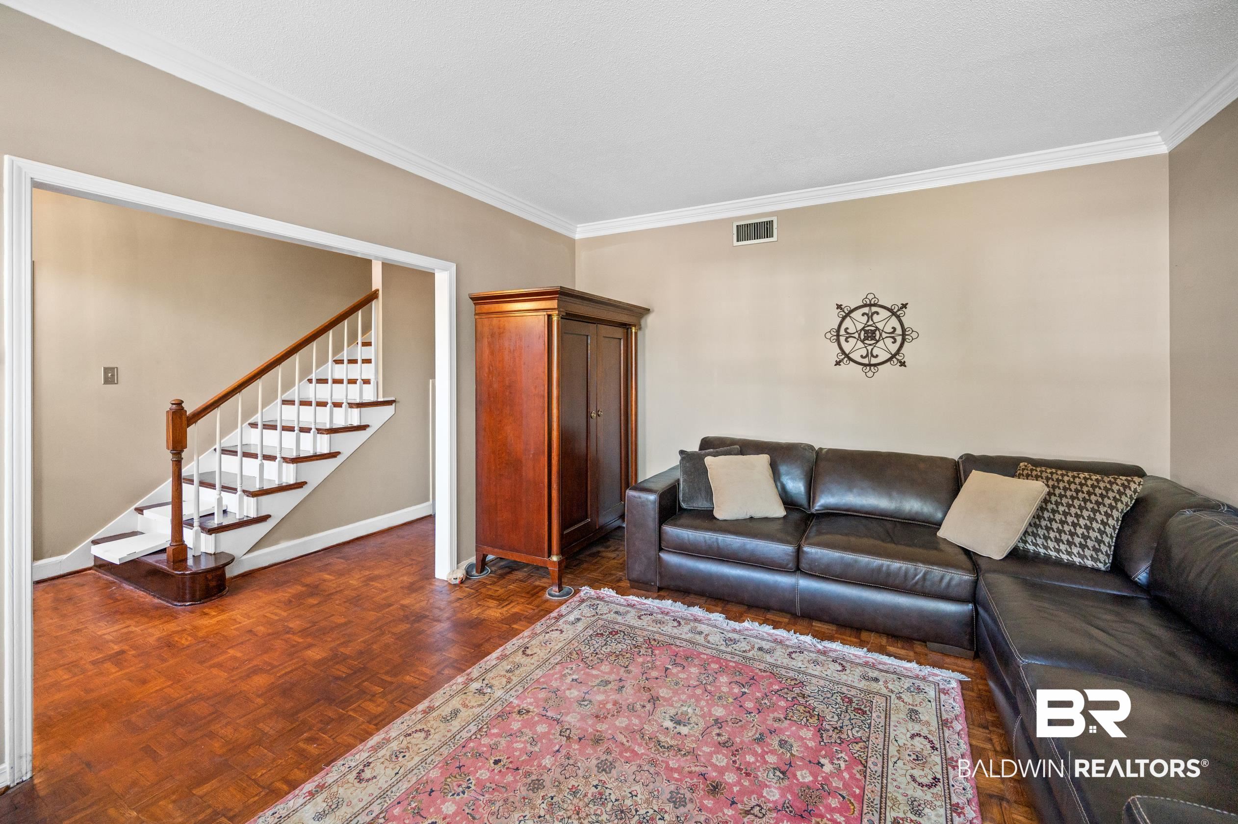 6705 Ridgeland Road South Mobile, AL 36695 - Photo 7 of 44 Living room featuring crown molding and dark parquet flooring