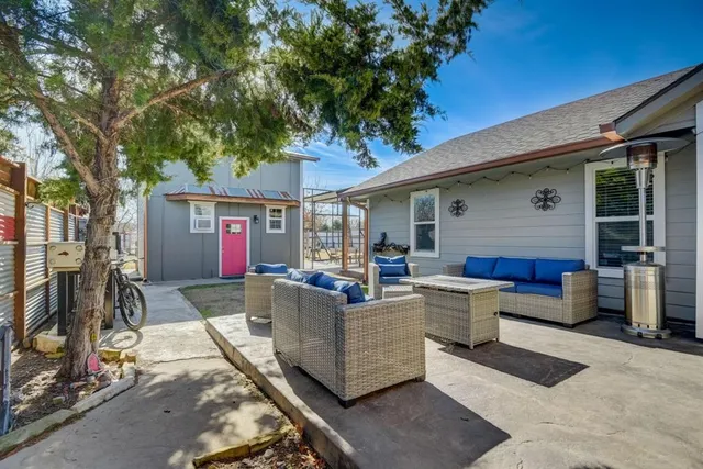 a building outdoor space with patio furniture and potted plants