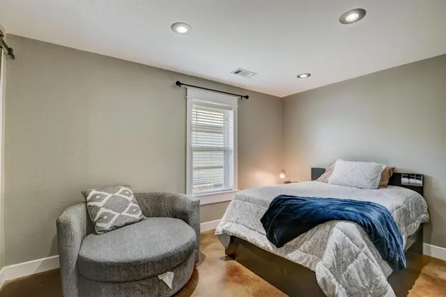 a bedroom with a bed and couch