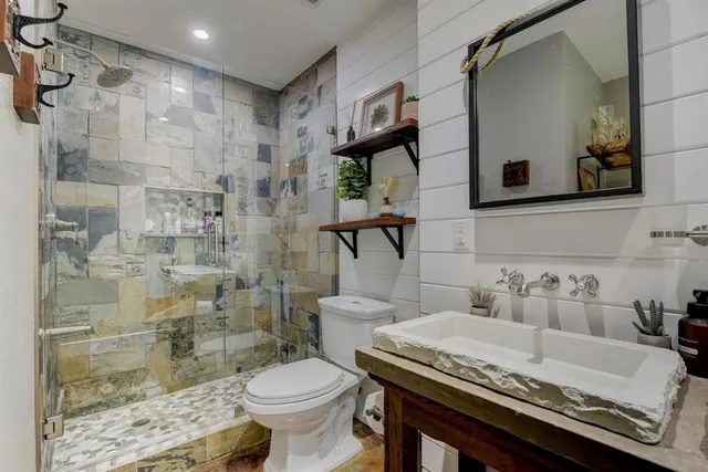 a bathroom with a sink toilet and shower