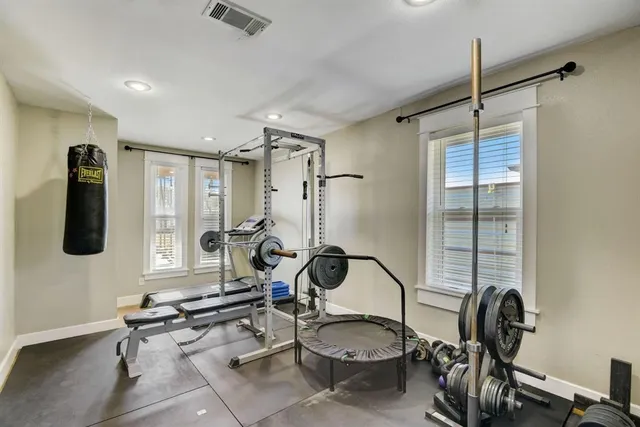 a room with gym equipment and windows