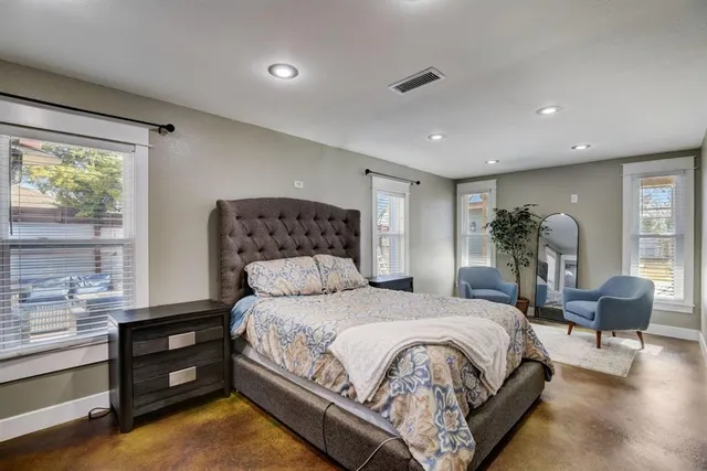 a bedroom with a bed and a chair