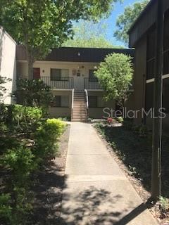 11705 Raintree Village Boulevard, Unit C Temple Terrace, FL 33617 - Photo 1 of 1 a view of a patio with table and chairs and potted plants