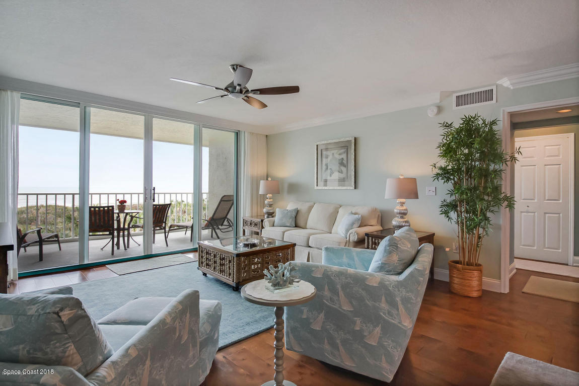 3400 Ocean Beach Boulevard, Unit 309 Cocoa Beach, FL 32931 - Photo 14 of 27 a living room with furniture and a large window