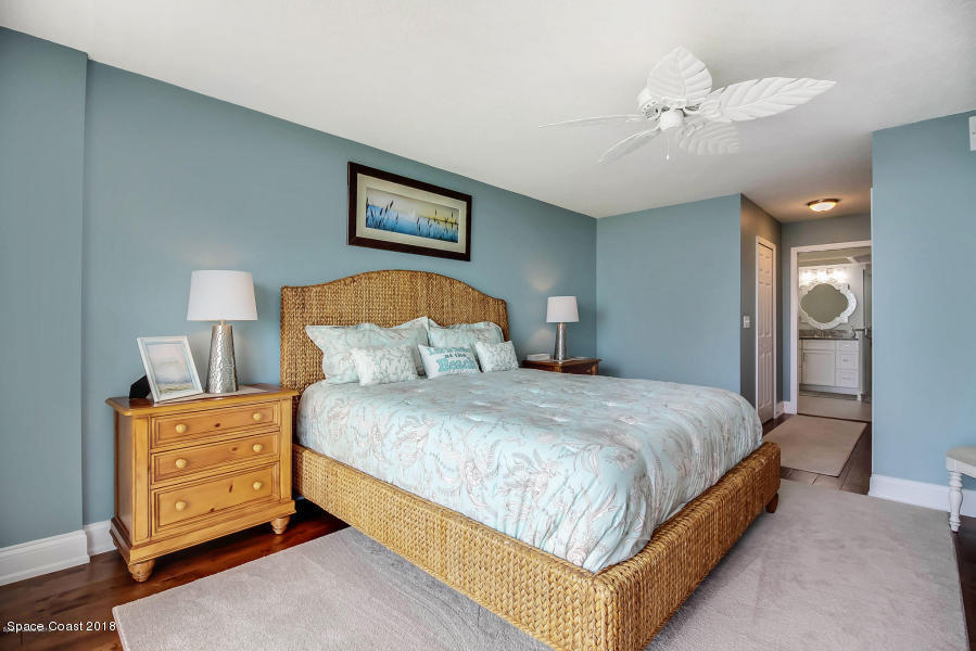 3400 Ocean Beach Boulevard, Unit 309 Cocoa Beach, FL 32931 - Photo 15 of 27 a bedroom with a bed and a night stand