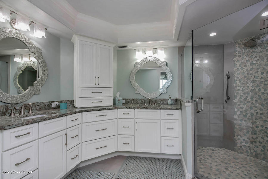 3400 Ocean Beach Boulevard, Unit 309 Cocoa Beach, FL 32931 - Photo 18 of 27 a bathroom with a granite countertop sink mirror and vanity