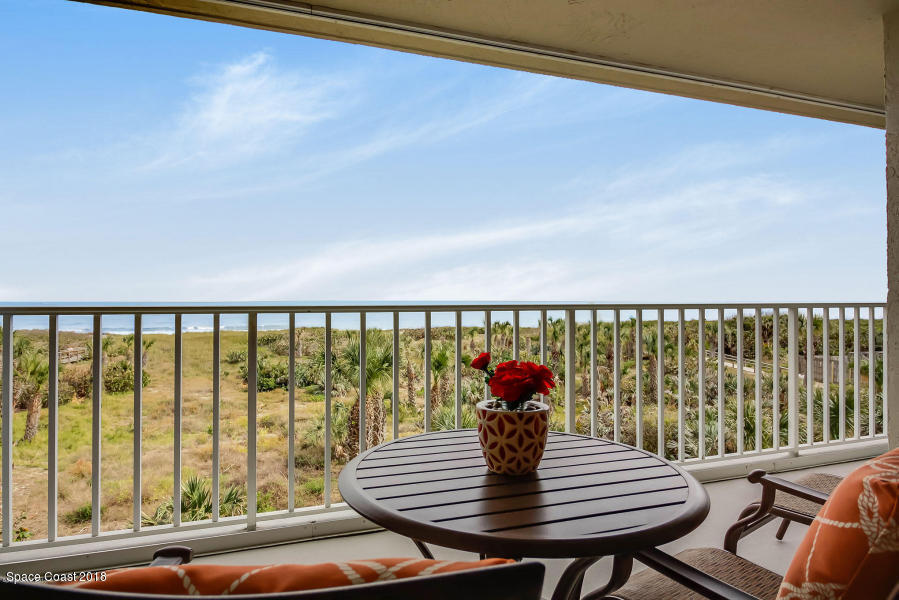 3400 Ocean Beach Boulevard, Unit 309 Cocoa Beach, FL 32931 - Photo 2 of 27 a living room with furniture and a window