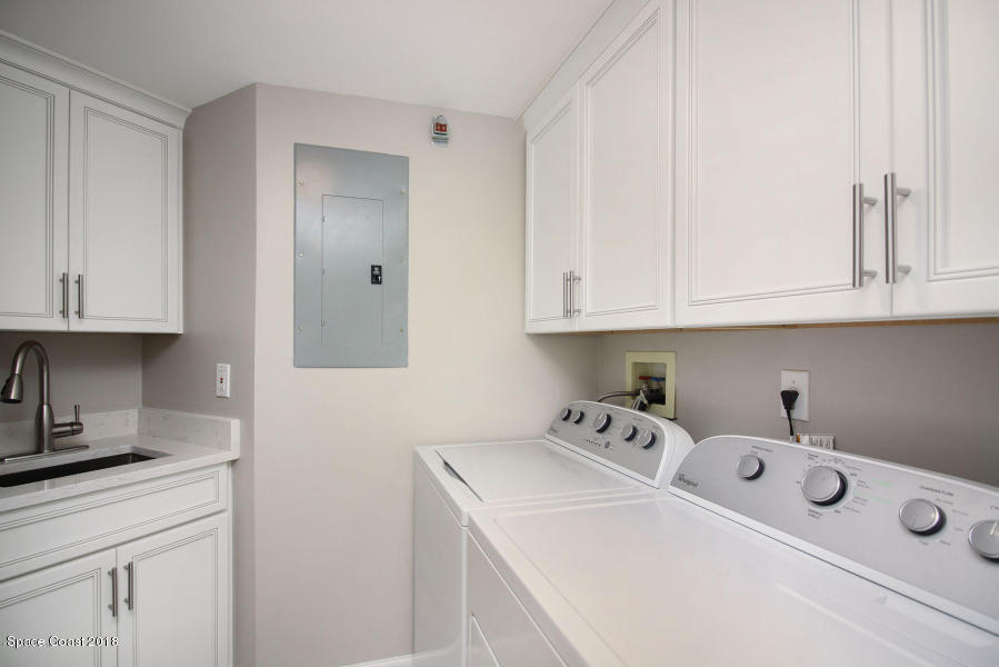 3400 Ocean Beach Boulevard, Unit 309 Cocoa Beach, FL 32931 - Photo 25 of 27 a utility room with dryer and washer