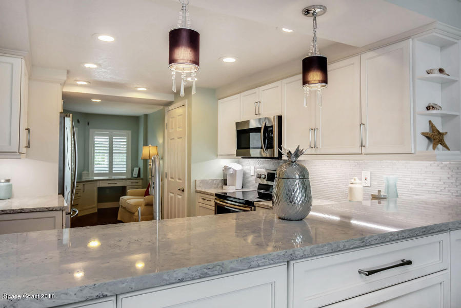 3400 Ocean Beach Boulevard, Unit 309 Cocoa Beach, FL 32931 - Photo 8 of 27 a kitchen with counter top space cabinets and appliances