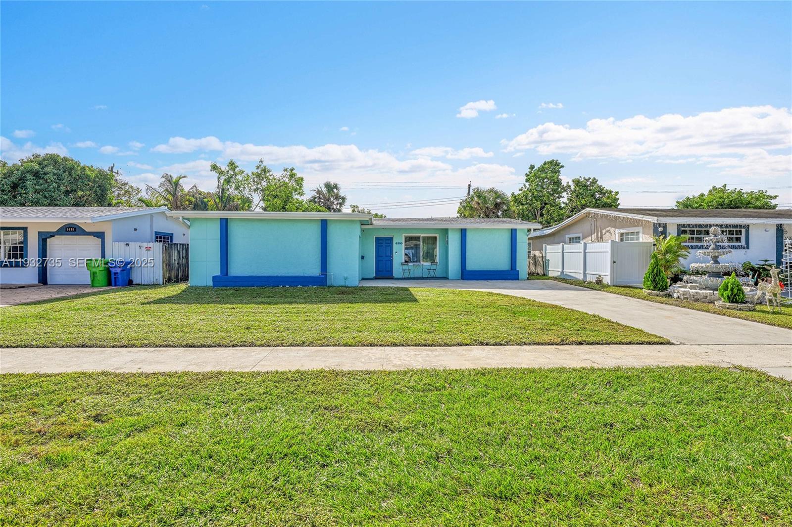6500 Northwest 27th Street Sunrise, FL 33313 - Photo 2 of 16 a view of house that has a big yard