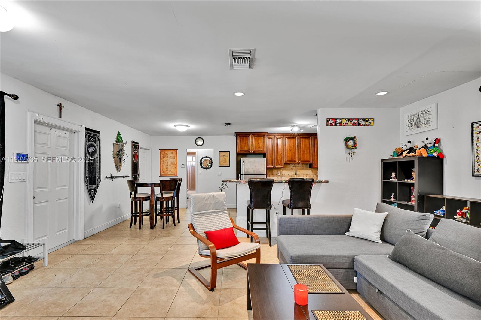 6500 Northwest 27th Street Sunrise, FL 33313 - Photo 4 of 16 a living room with furniture and kitchen view
