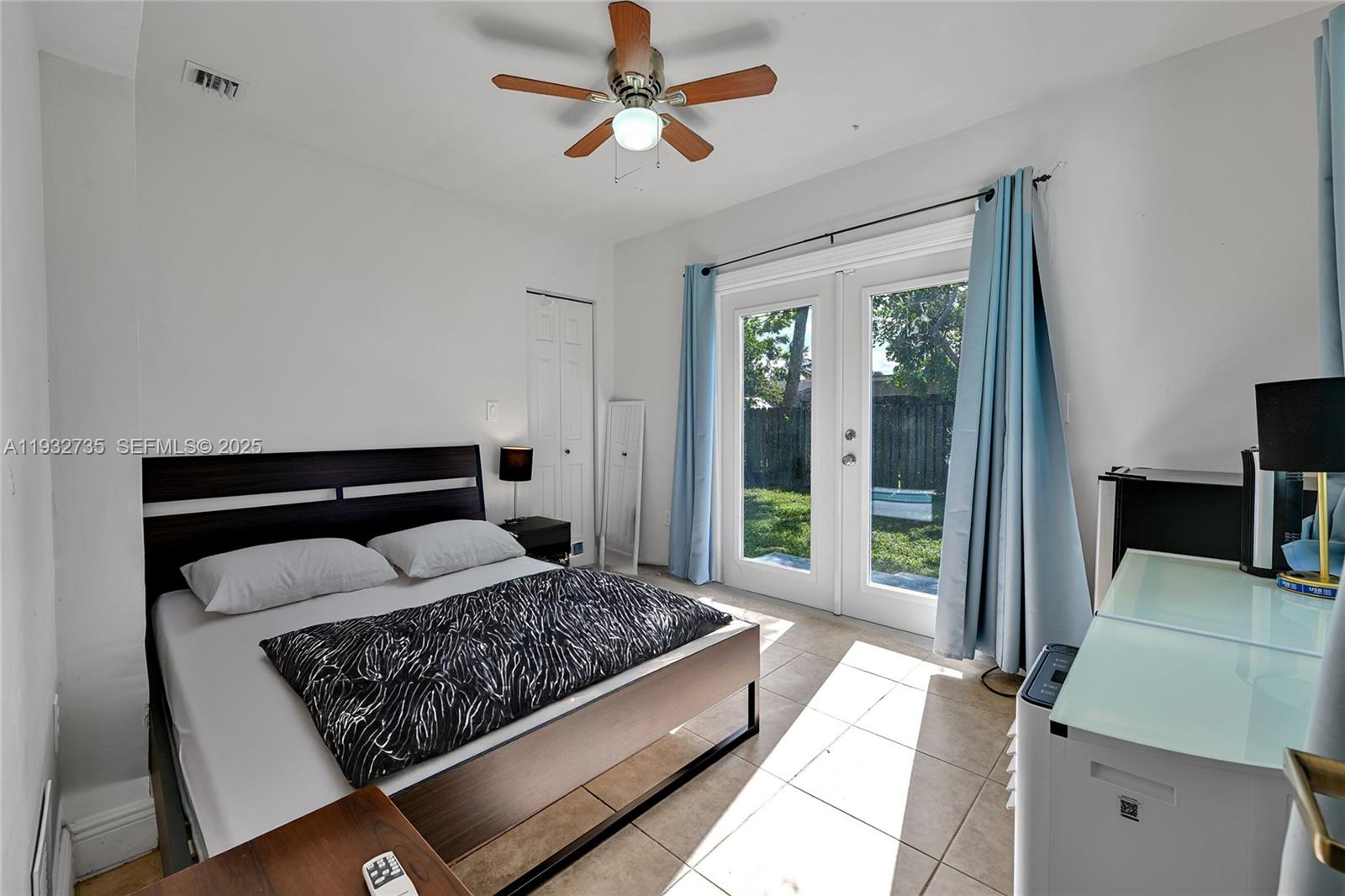 6500 Northwest 27th Street Sunrise, FL 33313 - Photo 9 of 16 a bedroom with a bed and glass door