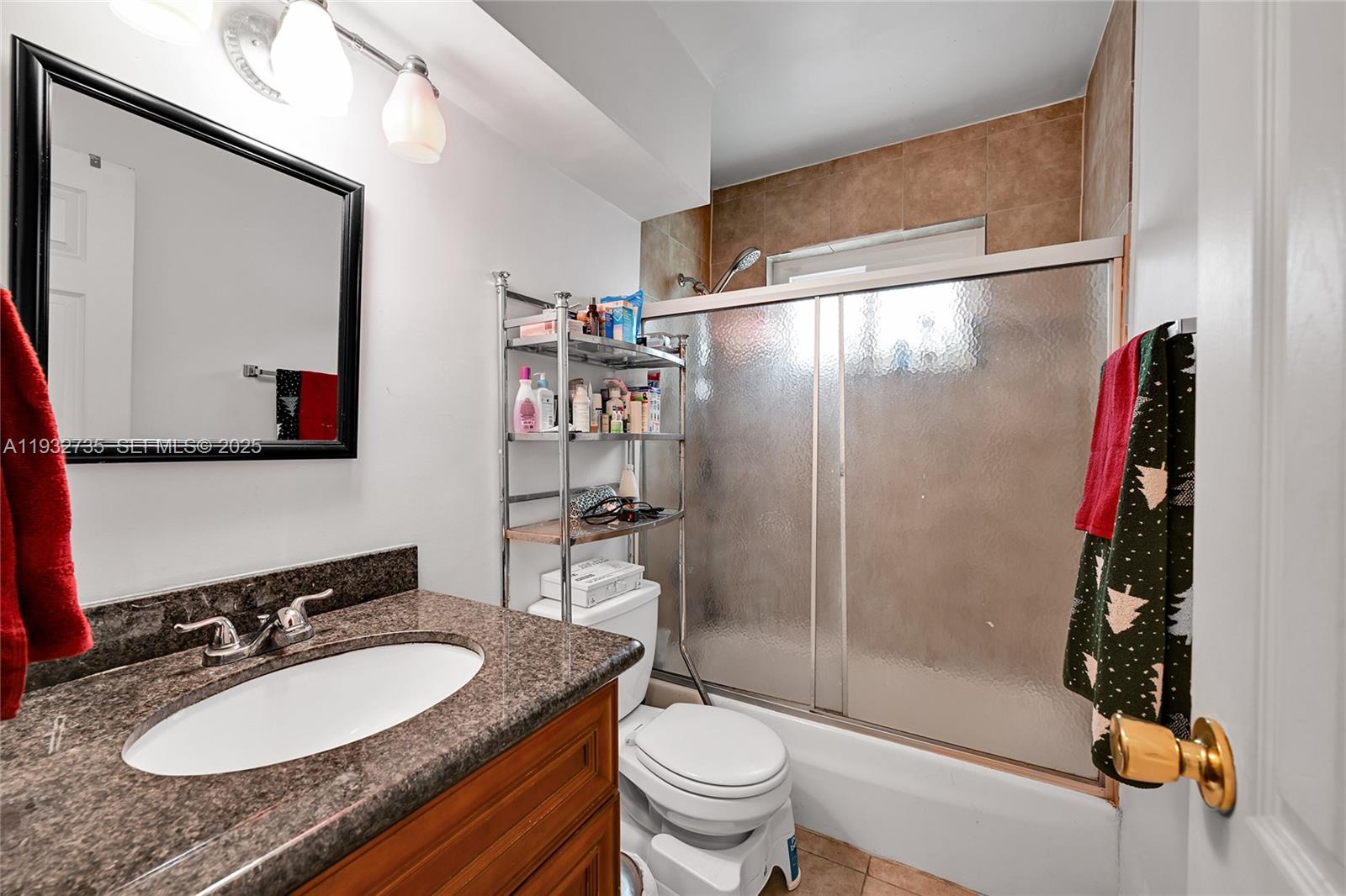 6500 Northwest 27th Street Sunrise, FL 33313 - Photo 10 of 16 a bathroom with a granite countertop sink toilet and shower