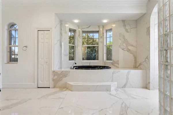 a bathroom with a granite countertop sink a large mirror and a shower
