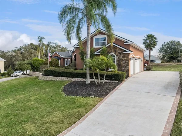 a front view of house with yard and green space