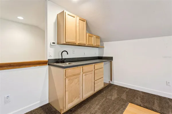 a view of a yard with an trees and buildings in the background