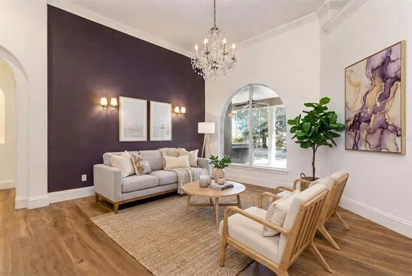 a bedroom with a large bed couch and a large window