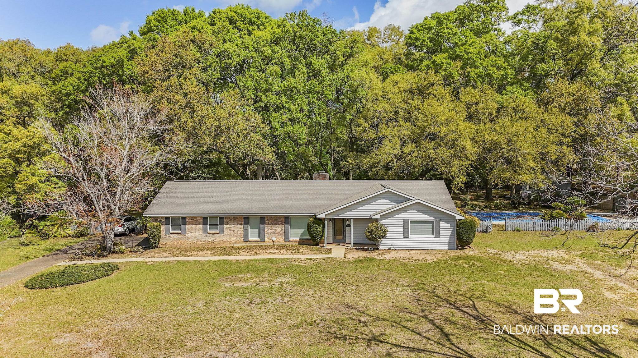 10207 Plantation Drive Daphne, AL 36526 - Photo 2 of 48 Ranch-style house with a chimney, a front yard, and brick siding