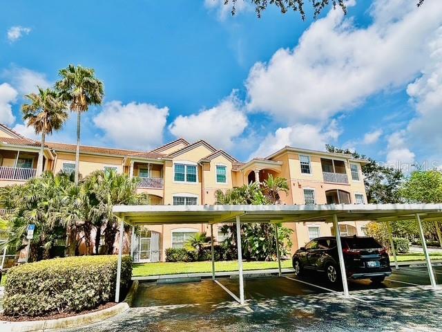 13500 Turtle Marsh Loop, Unit 825 Orlando, FL 32837 - Photo 1 of 19 a front view of a house with a garden