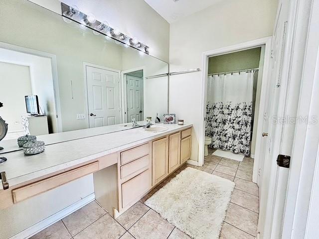 13500 Turtle Marsh Loop, Unit 825 Orlando, FL 32837 - Photo 12 of 19 a spacious bathroom with a shower sink and mirror