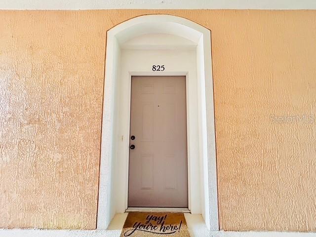 13500 Turtle Marsh Loop, Unit 825 Orlando, FL 32837 - Photo 18 of 19 a view of a hallway with wooden floor and a bathroom