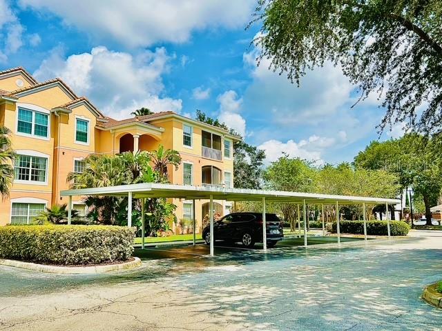 13500 Turtle Marsh Loop, Unit 825 Orlando, FL 32837 - Photo 2 of 19 a view of a house with a big yard and potted plants