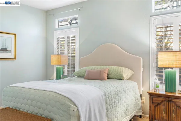 a bedroom with a large bed and a window