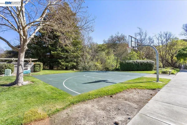 a view of a playground with basketball court