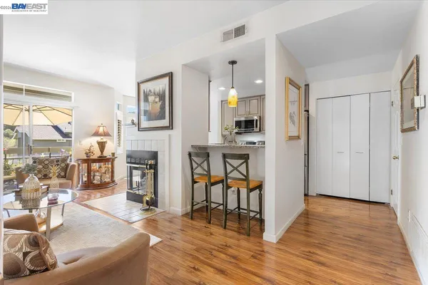 a living room with furniture a fireplace and a table
