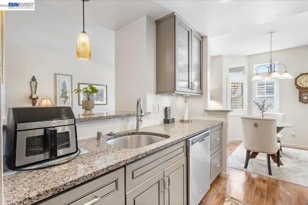 a kitchen with a sink cabinets and window