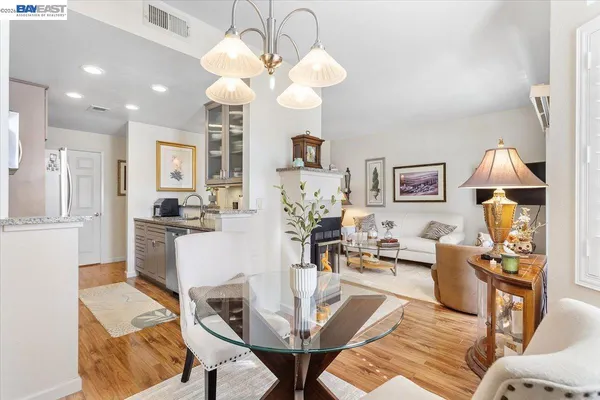 a living room with fireplace furniture and a chandelier