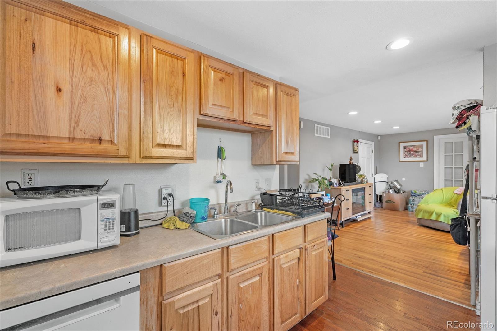 4956 Umatilla Street Denver, CO 80221 - Photo 11 of 33 a kitchen with lots of counter space and wooden floor
