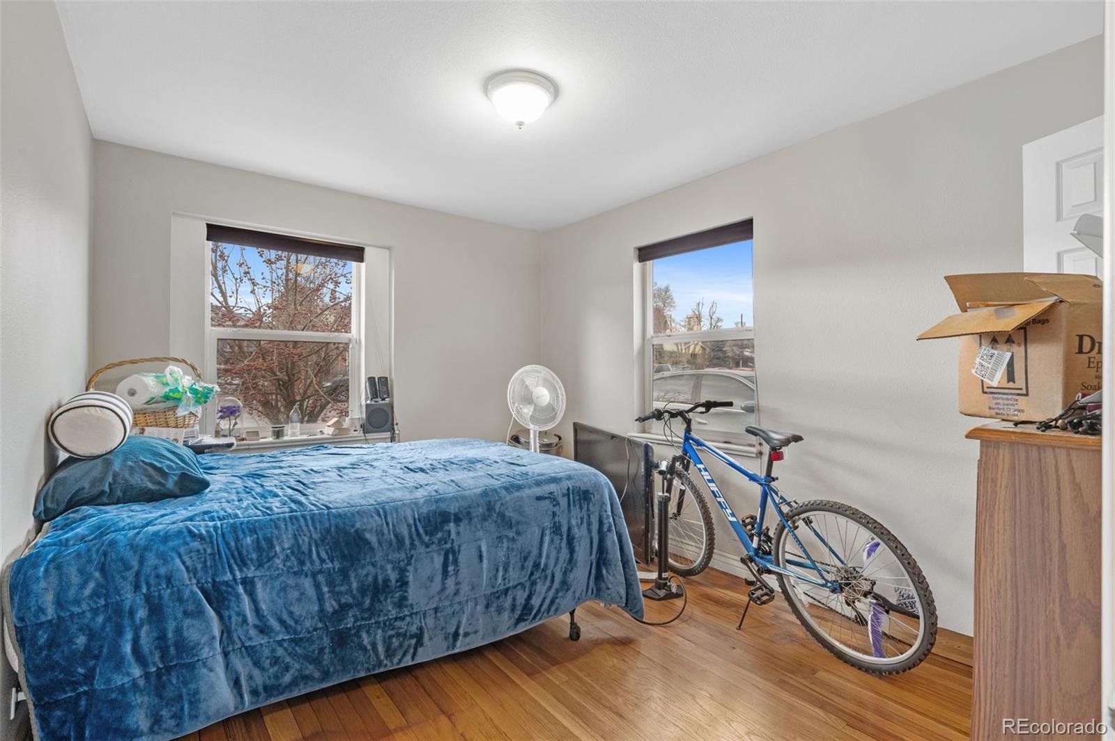 4956 Umatilla Street Denver, CO 80221 - Photo 12 of 33 a bedroom with a bed and a table in it