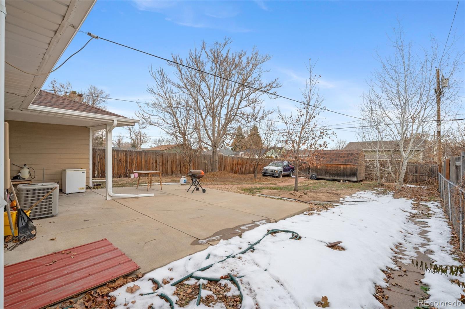4956 Umatilla Street Denver, CO 80221 - Photo 19 of 33 a view of a backyard with snow on the road