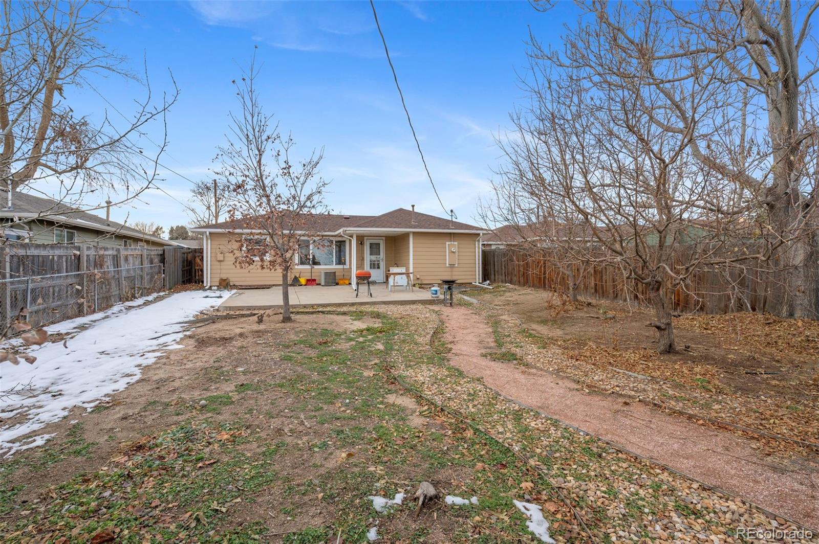 4956 Umatilla Street Denver, CO 80221 - Photo 21 of 33 a view of a house with a yard