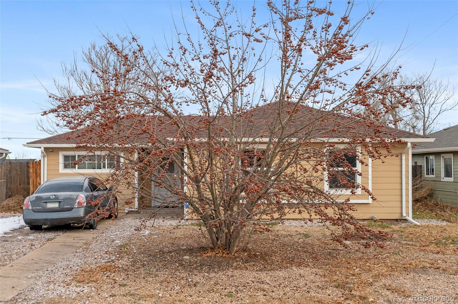 4956 Umatilla Street Denver, CO 80221 - Photo 4 of 33 a car parked in front of a house