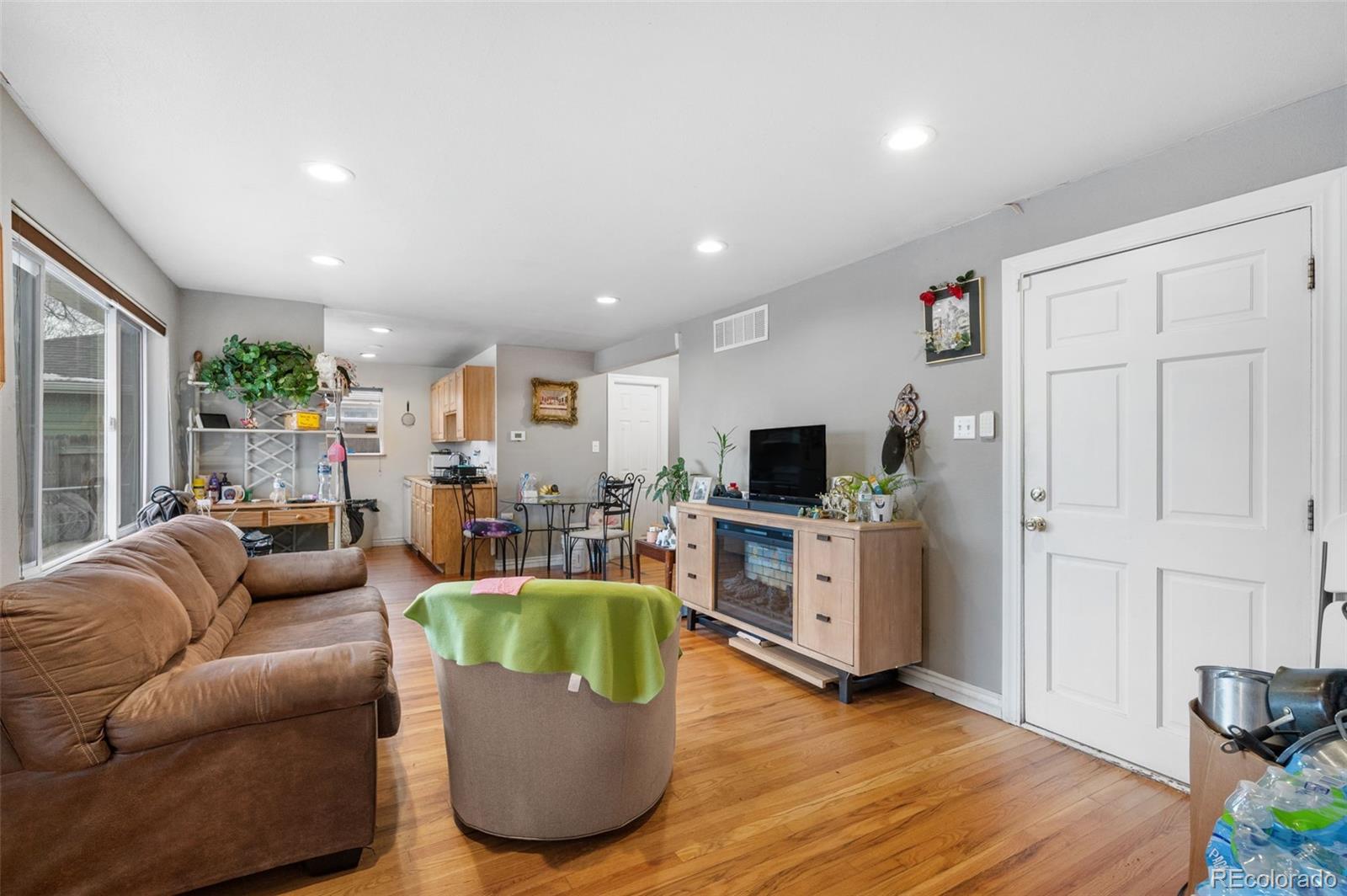 4956 Umatilla Street Denver, CO 80221 - Photo 6 of 33 a living room with furniture and a flat screen tv
