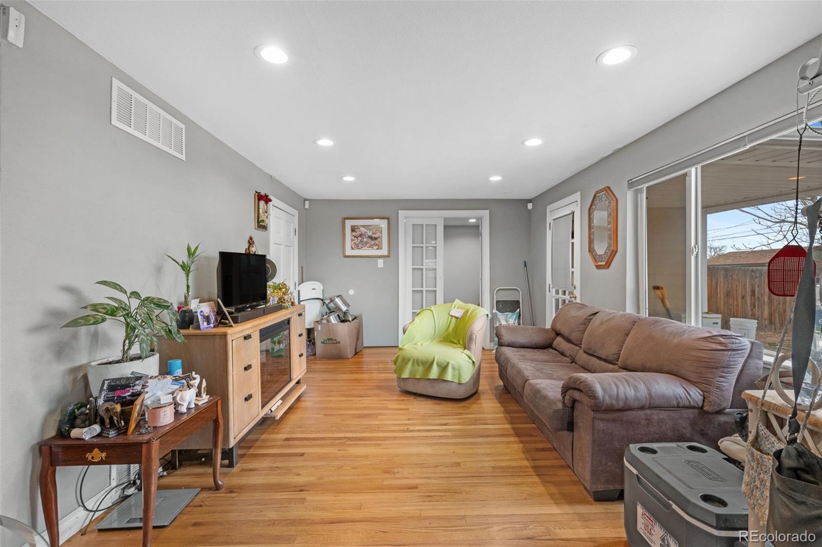4956 Umatilla Street Denver, CO 80221 - Photo 8 of 33 a living room with furniture and a flat screen tv